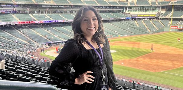Sarai Atchison standing in the stands of an empty Colorado Rockies stadium